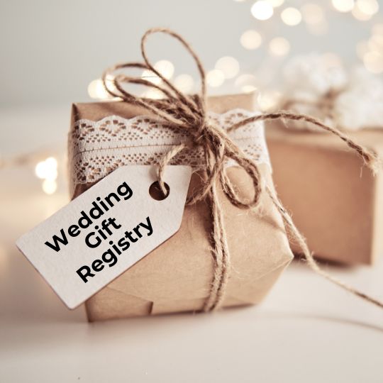 Gifts wrapped in
                        kraft paper and lace and tied with string. One
                        has a luggage tag attached that reads
                        "Wedding Gift Registry" in black ink.