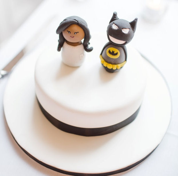 Single tier
                      wedding cake with figurines of a bride and Batman
                      on it