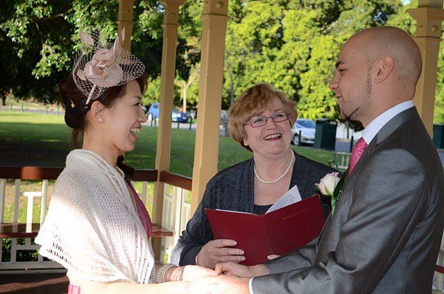Hiromi
                        & Leigh sharing a happy moment with
                        celebrant Jennifer Cram during their Warm and
                        Wonderful Weekday Wedding